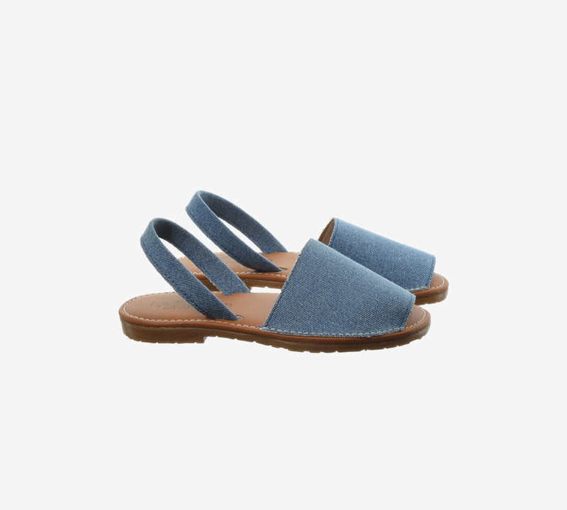 Blue Menina Step Menorquina in blue denim, handmade in Spain with traditional design, featuring a wooden sole and ankle straps.