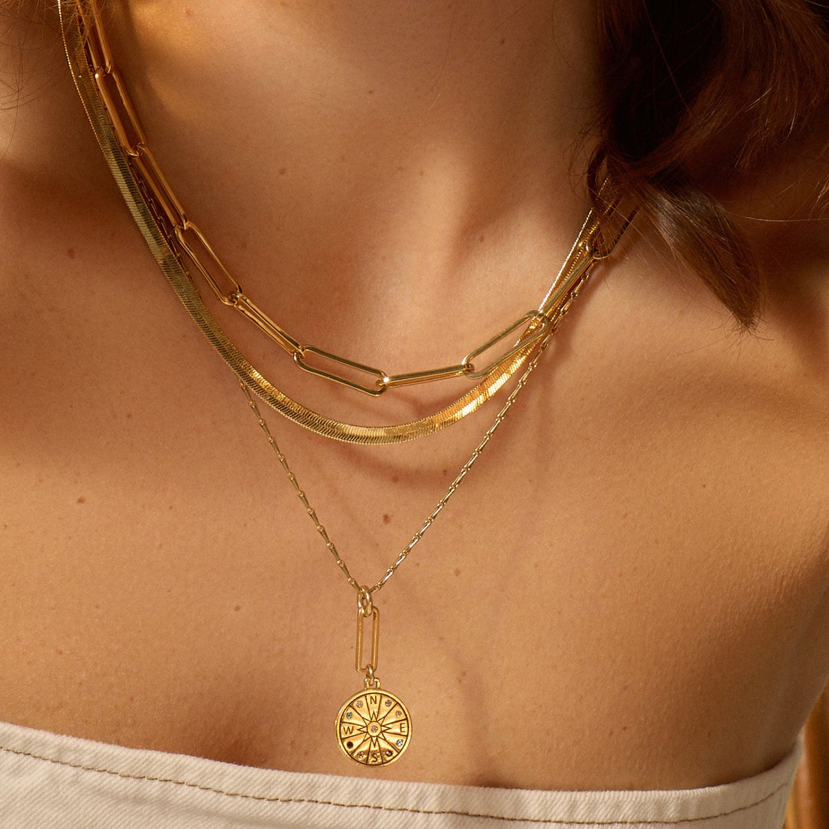 Gold Seeker Necklace by Mignonne Gavigan featuring a compass pendant with multi-crystals on a chain.