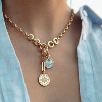 Mignonne Gavigan Voyager gold necklace with a mother-of-pearl charm pendant on a delicate chain.