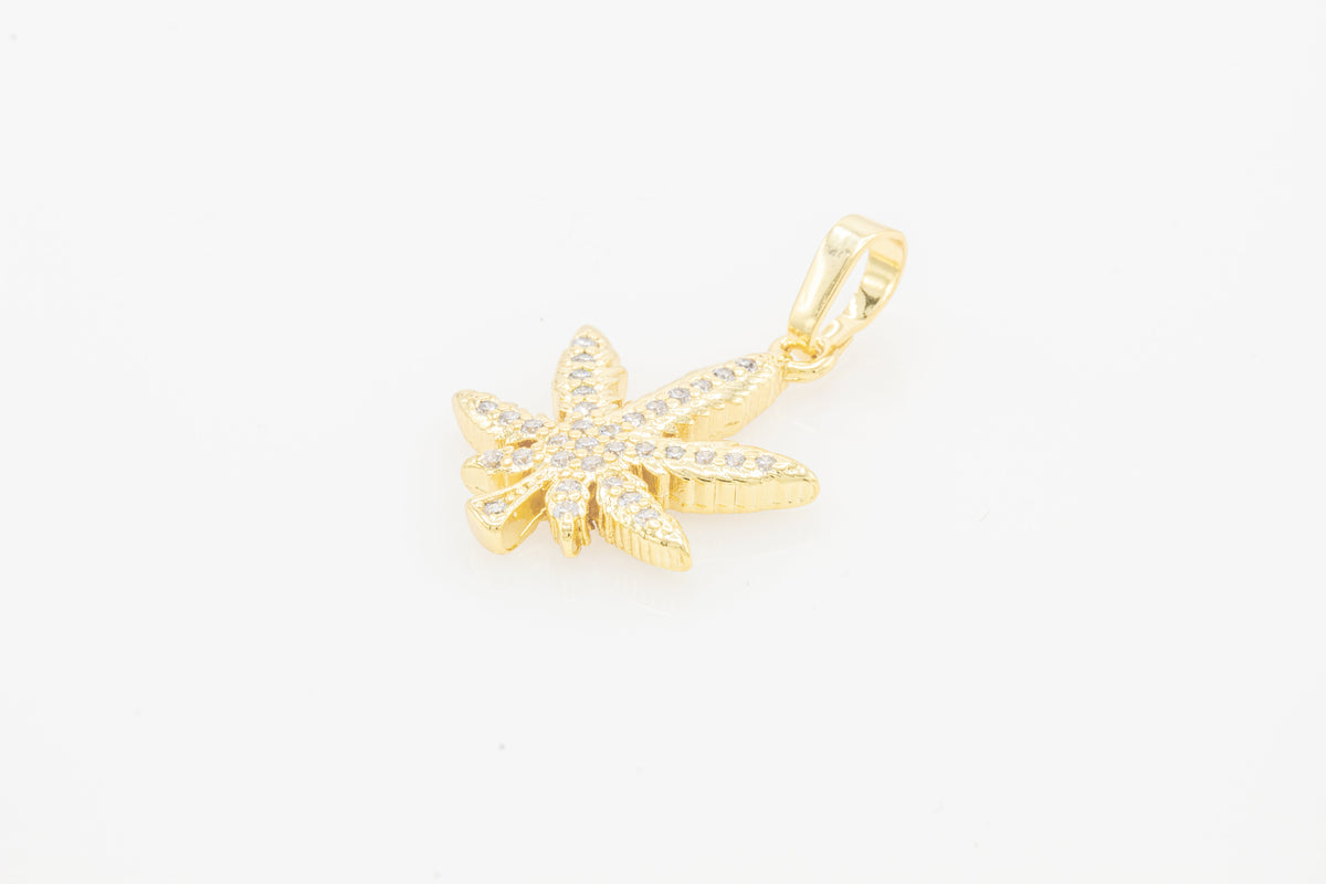 Gold-filled cannabis leaf pendant with cubic zirconia from JB Jewelry BLVD, elegant women’s fashion jewelry accessory.
