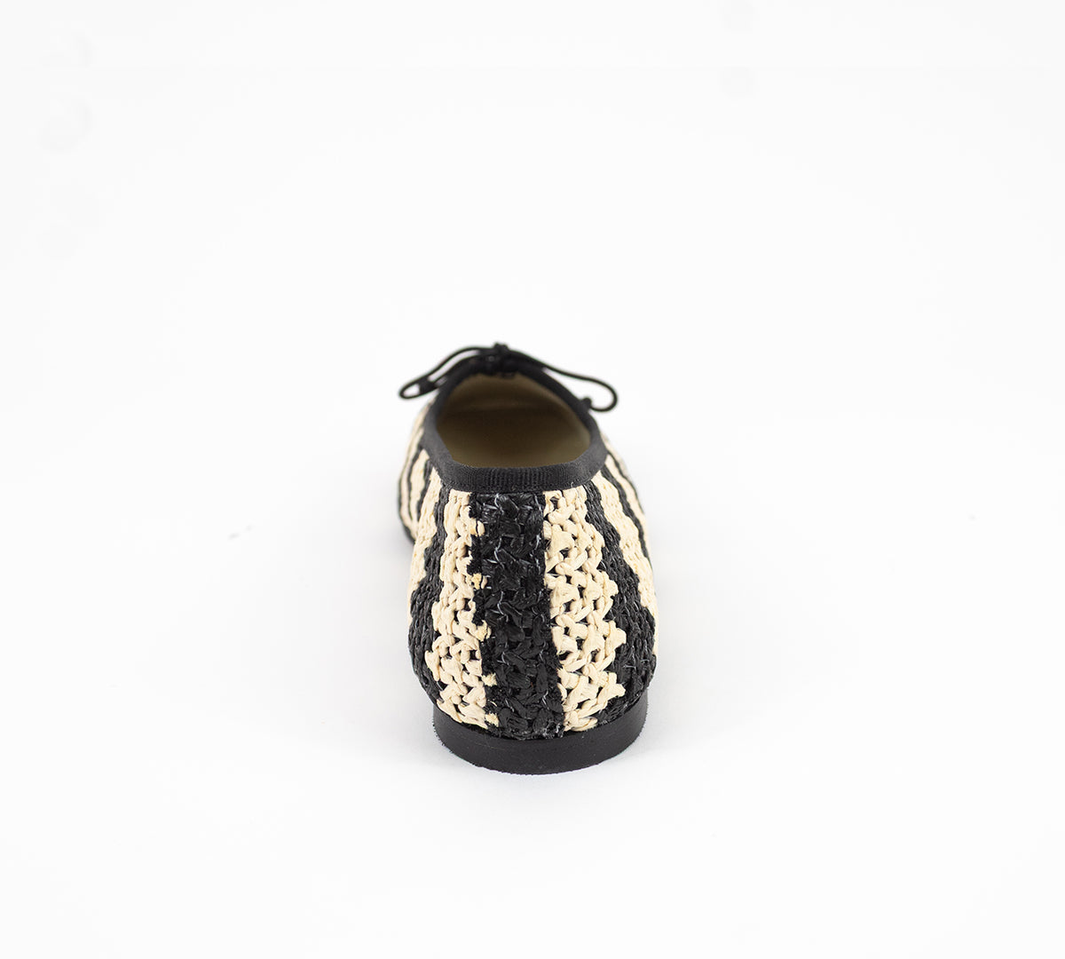 Handmade Lucy Raffia bag by Menina Step featuring woven raffia material and natural earthy tones, made in Spain.