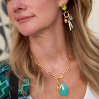 Mignonne Gavigan Natalia Charm Necklace featuring delicate chain and elegant charm detail on a neutral background.