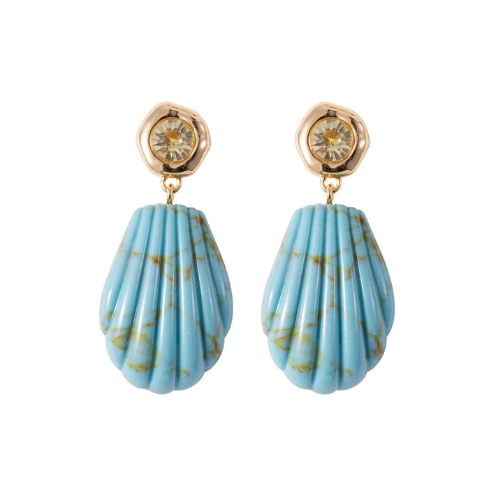 Mignonne Gavigan Natalia drop earrings with gold-tone design and intricate detailing, hanging gracefully from ear lobes.