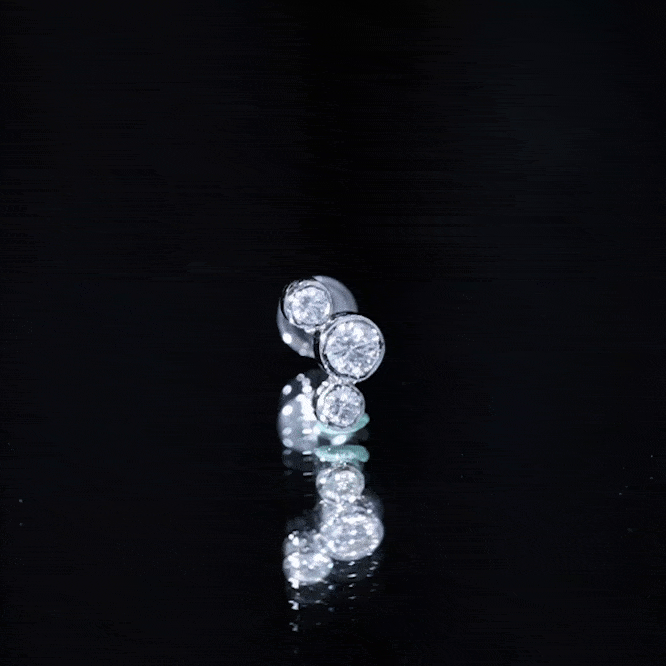 Yellow bezel set diamond three-stone helix earring from Rosec Jewels, showcasing sparkling diamond accents in a stylish body jewelry design.