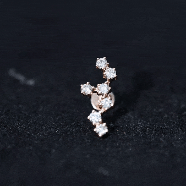Yellow diamond Leo constellation crawler earring for helix piercing, body jewelry by Rosec Jewels featuring star motifs.