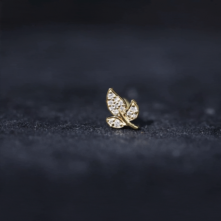 Gold diamond leaf cartilage stud earring in 18G Rosec Jewels body jewelry collection, featuring nature-inspired design for helix and tragus.
