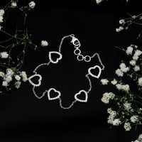 Rosec Jewels diamond heart chain bracelet in prong setting, showcasing sparkling diamonds on a delicate silver chain.