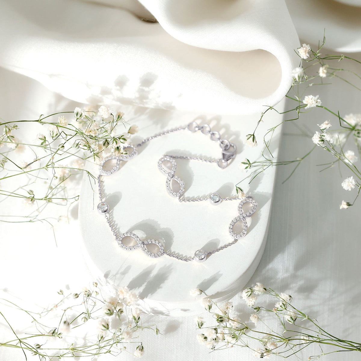 Certified Moissanite Infinity Chain Bracelet by Rosec Jewels featuring sparkling moissanite stones on a delicate silver chain.