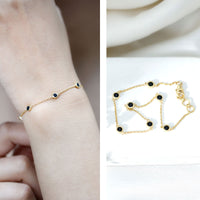 Bezel set black onyx seven-stone station chain bracelet by Rosec Jewels featuring polished black onyx stones on a silver chain.