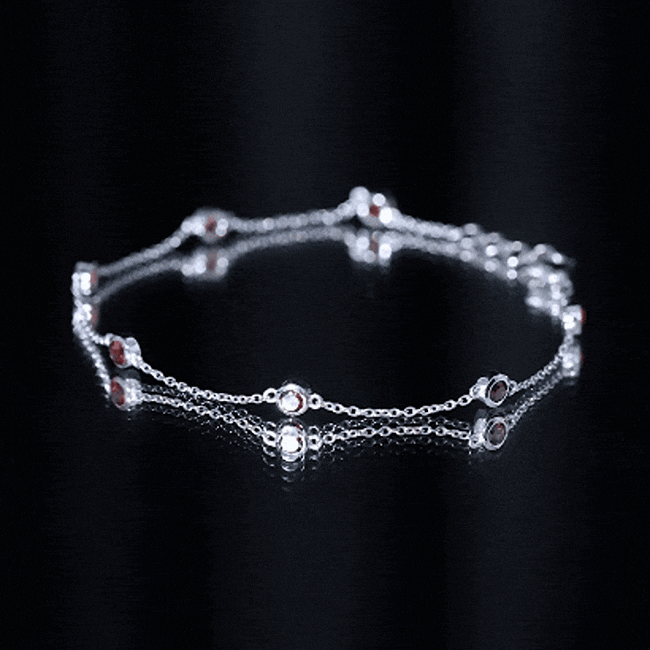Bezel set garnet seven-stone station chain bracelet by Rosec Jewels featuring vibrant red gemstones and gold-tone links.