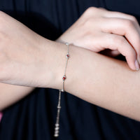 Bezel set garnet seven-stone station chain bracelet by Rosec Jewels featuring red gemstone accents on a delicate chain.