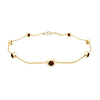 Bezel set garnet seven-stone station chain bracelet by Rosec Jewels, featuring polished metal links and vibrant red gemstones.