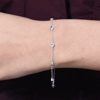 Bezel set aquamarine station bracelet for women by Rosec Jewels featuring blue gemstones on a silver chain.