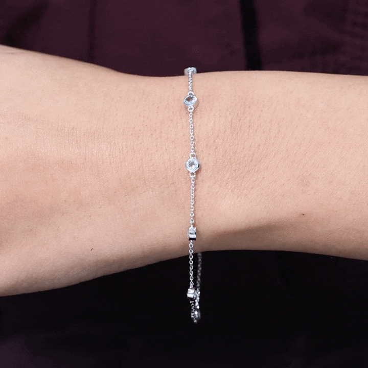 Bezel set aquamarine station bracelet for women by Rosec Jewels, featuring vibrant blue-green gemstones on a delicate chain.