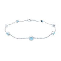 Bezel set aquamarine station bracelet for women by Rosec Jewels featuring oval aquamarine stones on a delicate silver chain.