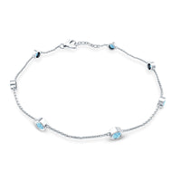 Bezel set aquamarine station bracelet for women by Rosec Jewels, featuring blue gemstones on a delicate metal chain.