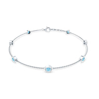 Bezel set aquamarine station bracelet for women by Rosec Jewels, featuring blue gemstone beads on a delicate silver chain.