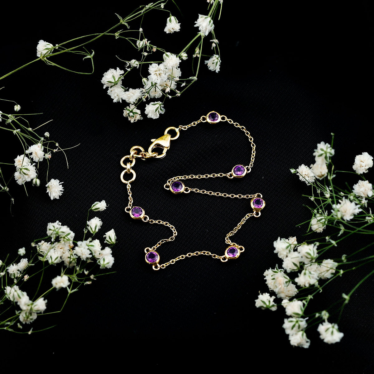 Real amethyst chain bracelet in bezel setting featuring polished purple gemstones on a delicate silver chain.