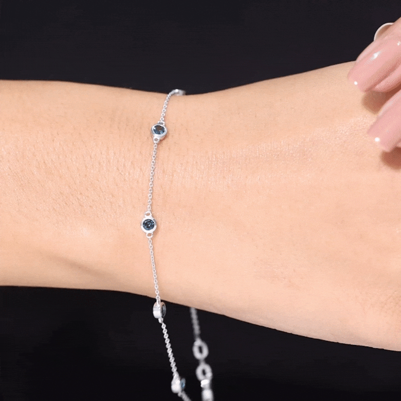 Bezel set London Blue Topaz station chain bracelet by Rosec Jewels, featuring blue gemstones on a delicate silver chain.