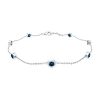 Rosec Jewels bezel set London Blue Topaz station chain bracelet with sparkling blue gemstones on a delicate silver chain.