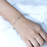 Bezel set London Blue Topaz station chain bracelet by Rosec Jewels, featuring blue topaz gemstones on a sleek silver chain.