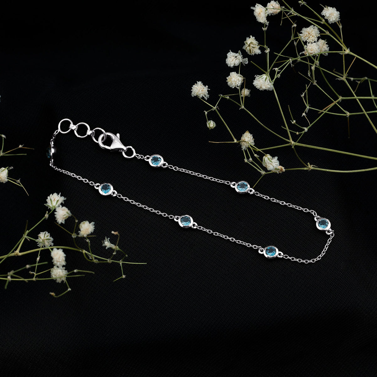 Bezel set London Blue Topaz station chain bracelet by Rosec Jewels featuring blue topaz gemstones on a silver chain