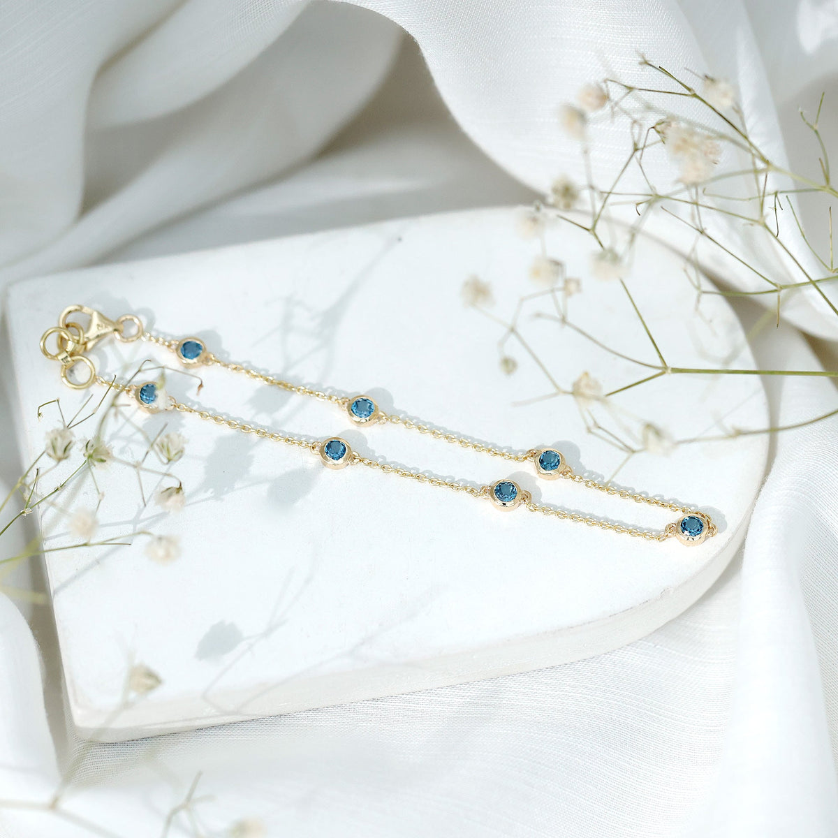 Bezel set London Blue Topaz station chain bracelet by Rosec Jewels featuring blue topaz gemstones on a delicate silver chain