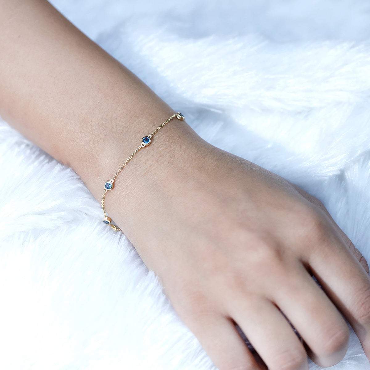 Bezel set London Blue Topaz station chain bracelet with silver links by Rosec Jewels.