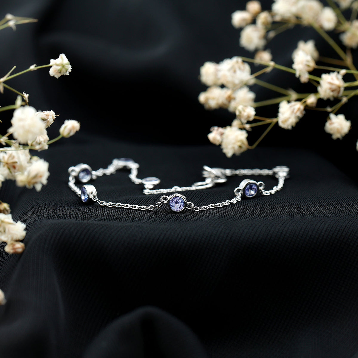 Rosec Jewels natural Tanzanite chain bracelet for women, featuring vibrant blue gemstones on a delicate silver chain.