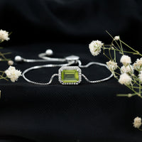 Emerald cut peridot and diamond bolo chain bracelet with 1.8 carats, featuring Rosec Jewels branding and intricate silver links.