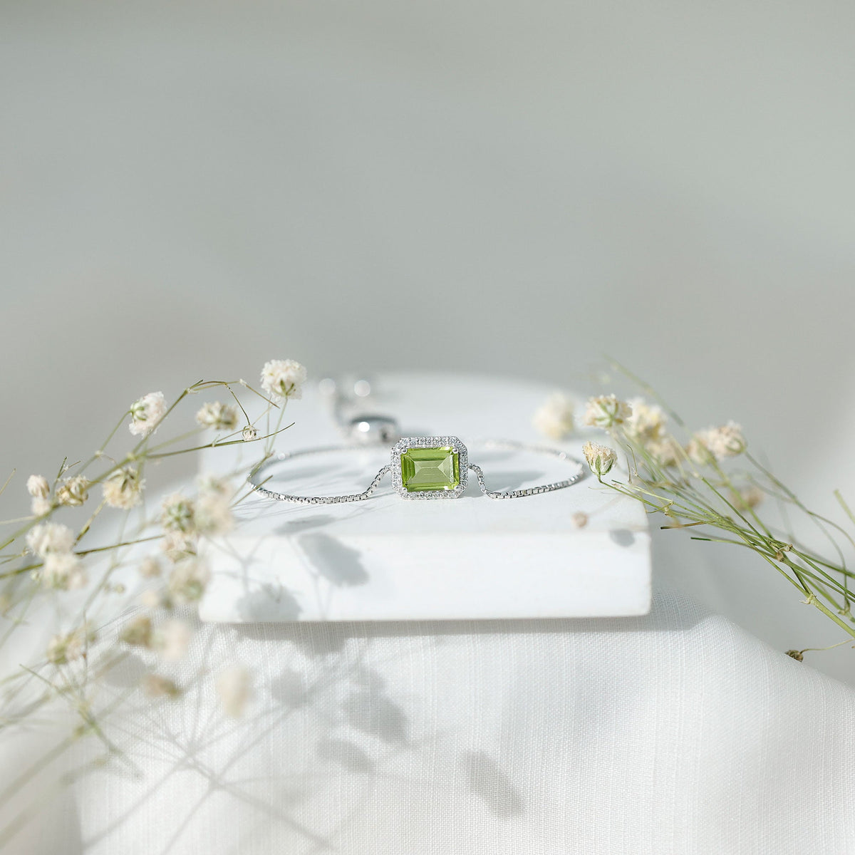 Emerald cut peridot and diamond bolo chain bracelet by Rosec Jewels, featuring a 1.8-carat green gemstone design.