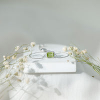Emerald cut peridot and diamond bolo chain bracelet by Rosec Jewels, featuring a 1.8-carat green gemstone design.