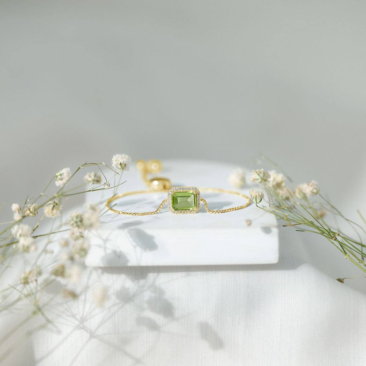 Emerald cut peridot and diamond bolo chain bracelet featuring 1.8 carats of gemstones, designed by Rosec Jewels.