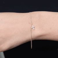 Yellow moissanite cross charm bracelet for women by Rosec Jewels, featuring a delicate chain with sparkling cross pendant.