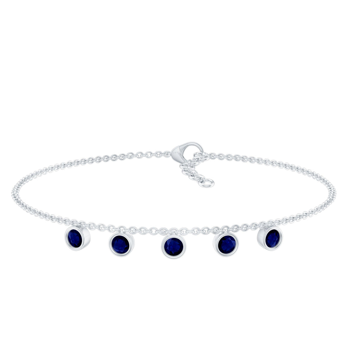 Bezel set blue sapphire charm bracelet by Rosec Jewels featuring a delicate silver chain with blue sapphire accents.
