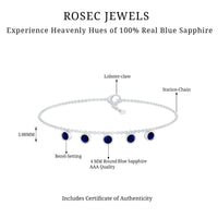 Bezel set blue sapphire charm bracelet by Rosec Jewels featuring a silver chain and sparkling blue sapphire stones.