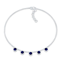 Bezel set blue sapphire charm bracelet by Rosec Jewels featuring a delicate silver chain with blue sapphire gemstones.