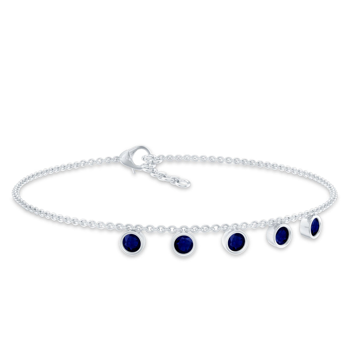 Bezel set blue sapphire charm bracelet by Rosec Jewels featuring a delicate silver chain with blue sapphire stones.
