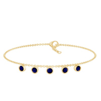 Bezel set blue sapphire charm bracelet by Rosec Jewels featuring a row of sparkling blue sapphires on a delicate bracelet chain.