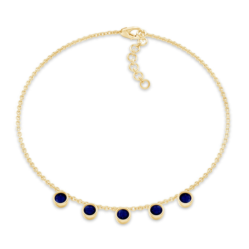 Bezel set blue sapphire charm bracelet by Rosec Jewels featuring a delicate silver chain and sparkling blue sapphires.