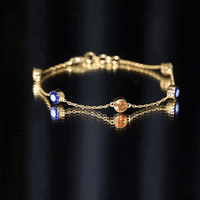 Bezel set fire opal evil eye station bracelet for women by Rosec Jewels, featuring vibrant fire opal stones along a delicate bracelet.