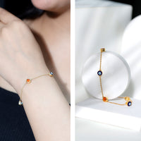 Bezel set fire opal evil eye station bracelet for women by Rosec Jewels, featuring colorful gemstone beads and protective evil eye charms.