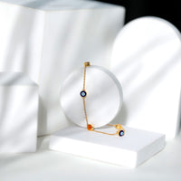 Bezel set fire opal evil eye station bracelet for women by Rosec Jewels featuring vibrant fire opal stones on a delicate bracelet chain
