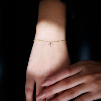 Rosec Jewels certified diamond cross chain bracelet showing a delicate silver bracelet with diamond accents and a cross pendant.