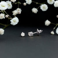 Brilliant cut diamond stud earrings in prong setting by Rosec Jewels, showcasing sparkling diamonds on a sleek metal stud.