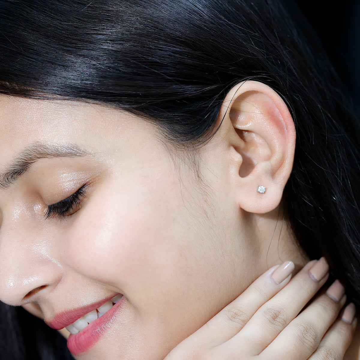 Brilliant cut diamond stud earrings in prong setting by Rosec Jewels, showcasing sparkling diamonds on a sleek metal background.