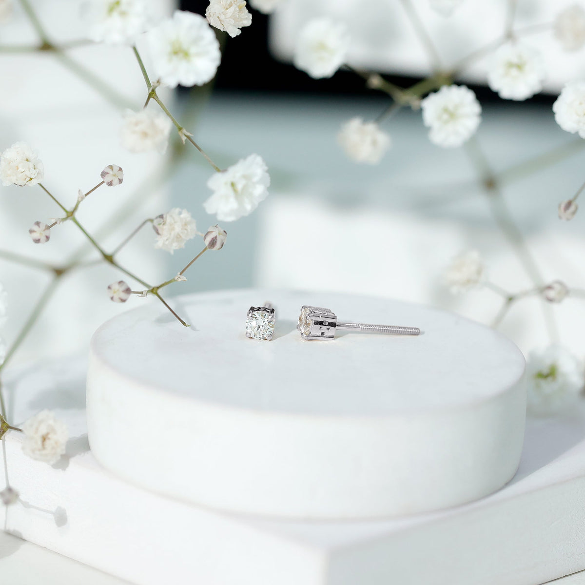 Brilliant cut diamond stud earrings in prong setting by Rosec Jewels, showcasing sparkling diamonds on a sleek metal backing.
