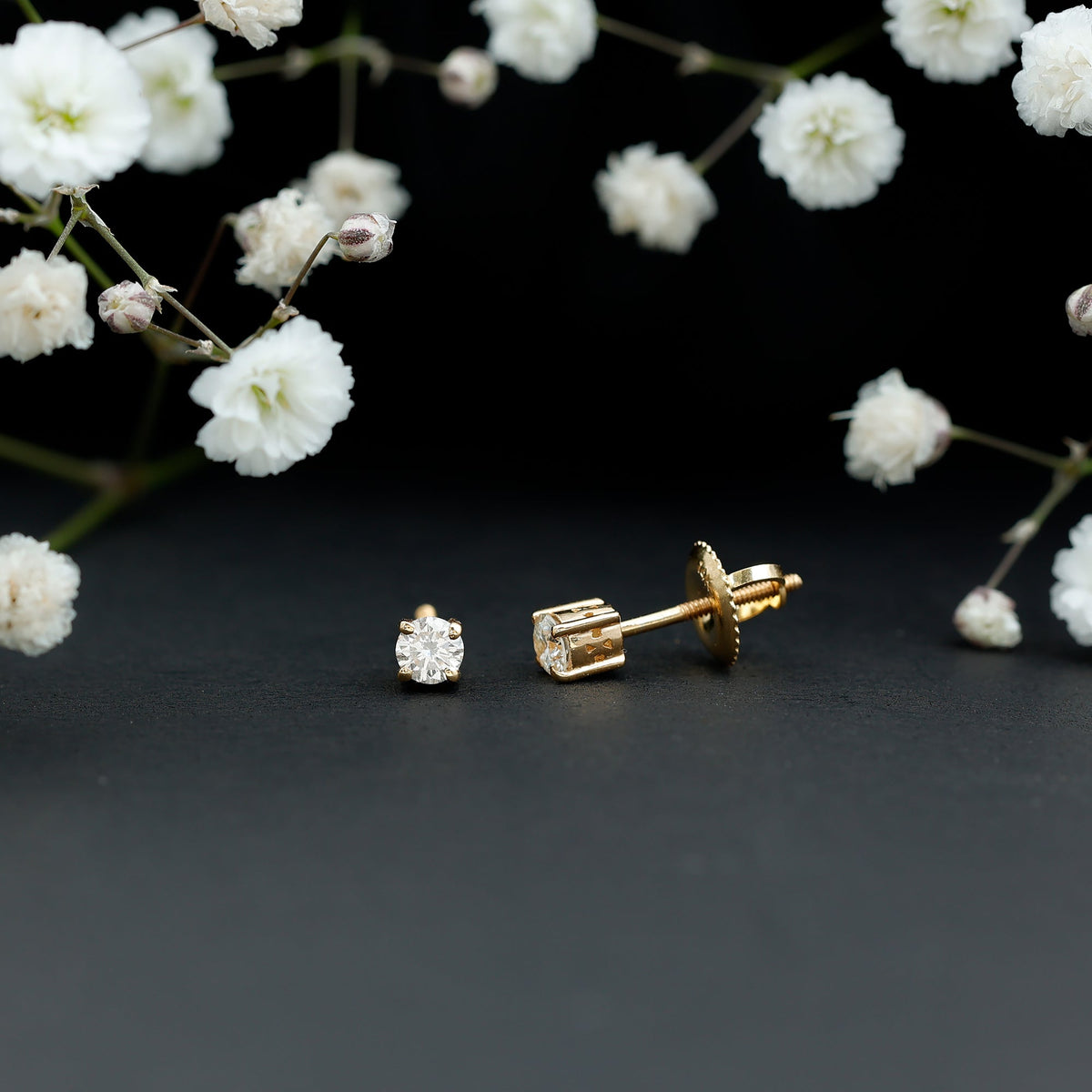 Brilliant cut diamond stud earrings in prong setting by Rosec Jewels, showcasing sparkling diamonds on a sleek metal backing.