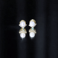 Rosec Jewels modern stud earrings featuring freshwater pearl and diamond accents on a sleek design.