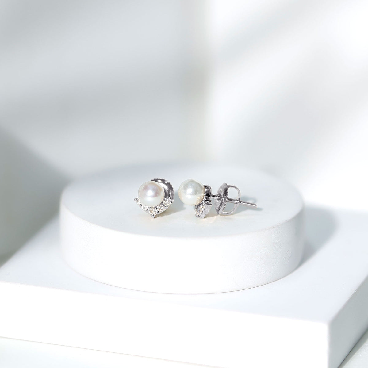 Rosec Jewels modern stud earrings featuring freshwater pearls and diamonds, showcasing elegant jewelry craftsmanship.